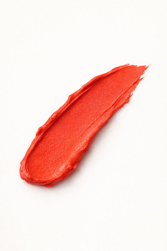Honor the House Blush swatch shade 04 Solar Bloom - bright poppy red-orange shade showing buildable coverage.