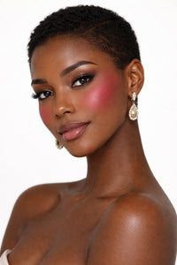 Honor The House Golden Cheek Cream Blush in 06 Hot Clay on model's cheeks.