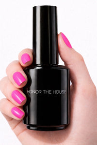 Bubble Gum Pink vegan nail polish on white model hands holding product bottle by Honor The House