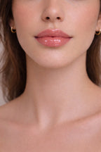 Honor The House SPF 30 Lip Balm in Cabernet Grape on fair skin model's lips.