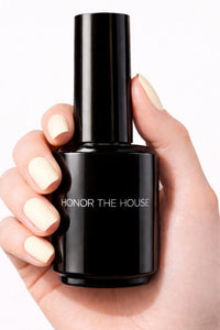 French Vanilla vegan nail polish on white model hands holding product bottle by Honor The House