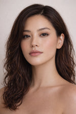 Honor The House Drippin' Gold Liquid Highlighter in Golden Hour blended on Asian model's cheeks.