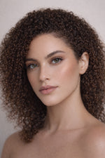Honor The House Drippin' Gold Liquid Highlighter in Honey Soft Glow on display on a model's cheek.