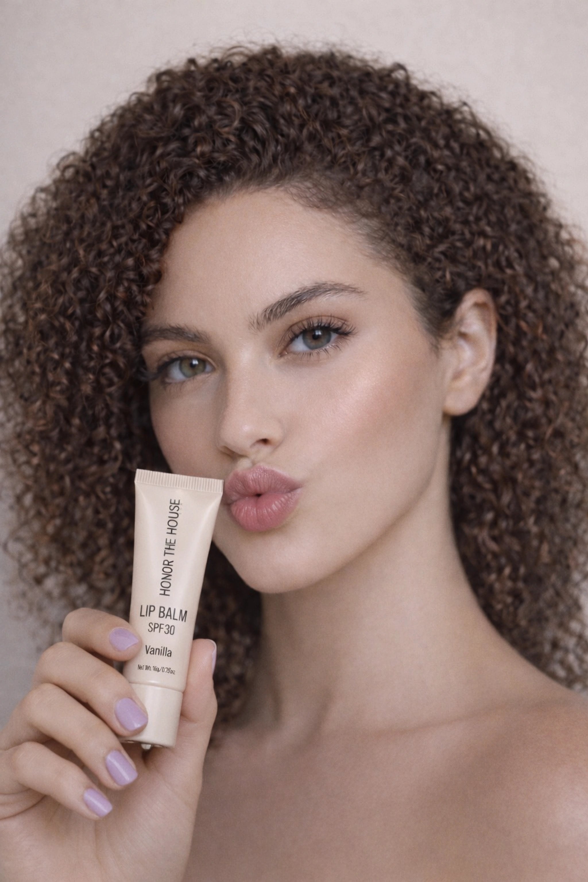 Honor The House Caribbean Sun SPF 30 French Vanilla being shown off by pretty model with curly hair.