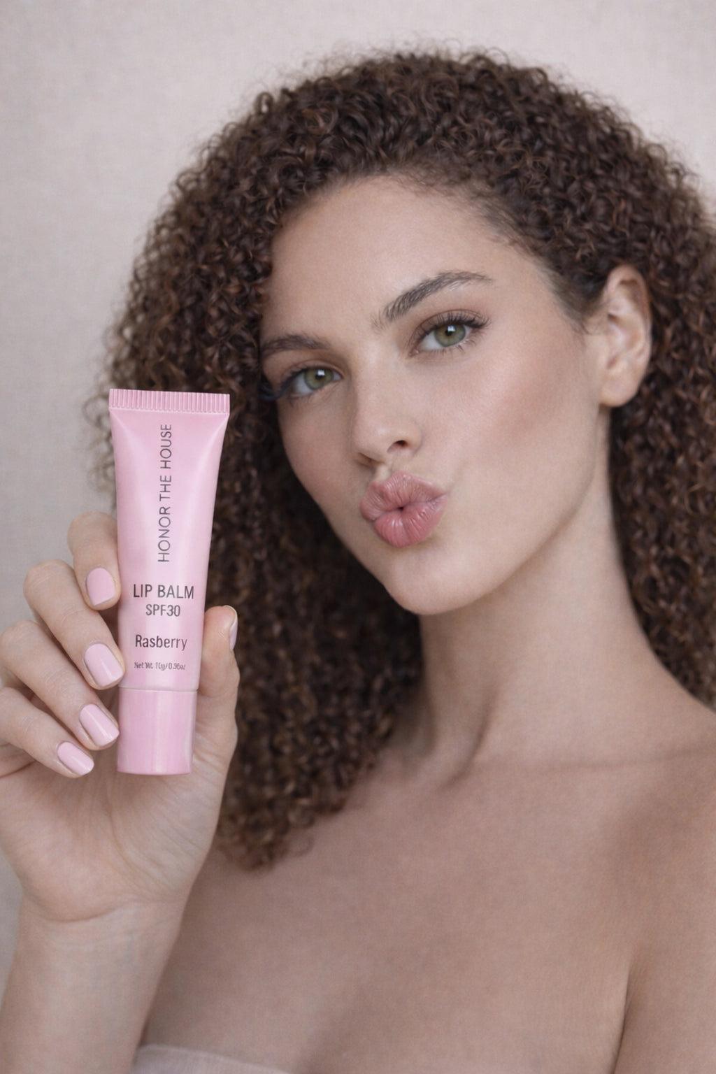 Honor The House Caribbean Sun SPF 30 Rum Raspberry being showcased by model with curly hair.