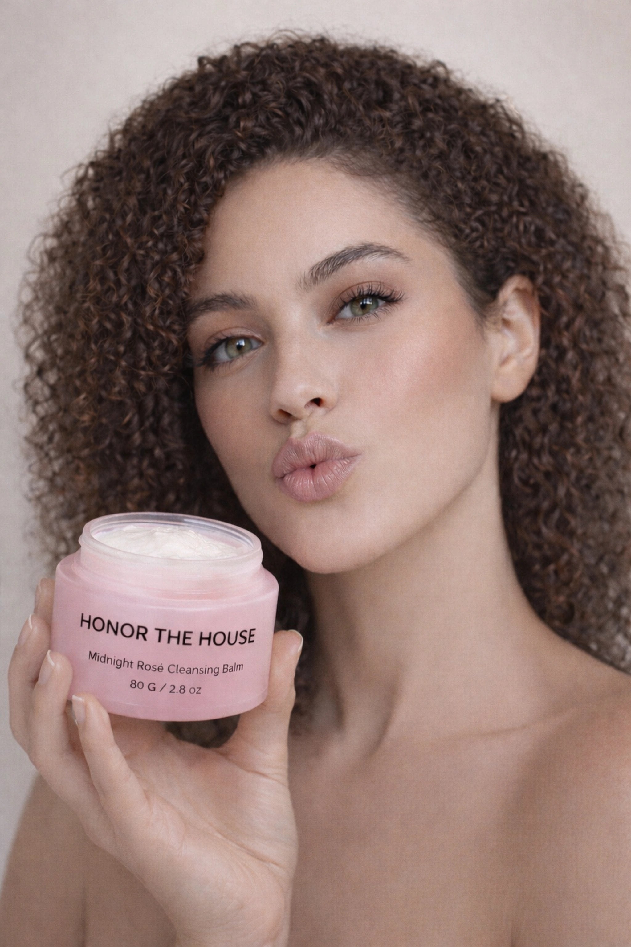 Honor The House Cleanse Your Spirit Cleansing Balm being showcased by a model with hazel eyes and curly hair.