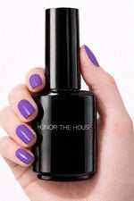 Royal Purple vegan nail polish on white model hands holding product bottle by Honor The House