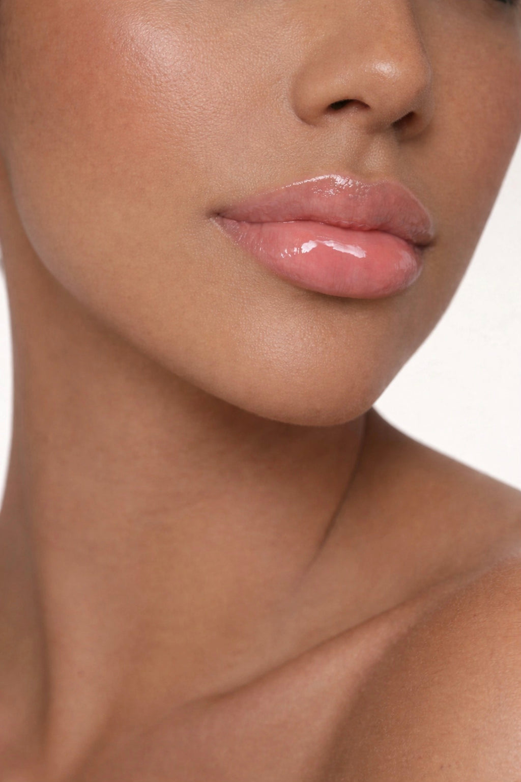 Olive skin model showcasing Honor The House Caribbean Sun SPF 30 Lip Balm in Rum Raspberry flavor.