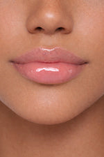 Arab model showcasing Honor The House Caribbean Sun SPF 30 Lip Balm in Rum Raspberry flavor.