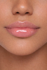 Arab model showcasing Honor The House Caribbean Sun SPF 30 Lip Balm in Rum Raspberry flavor.