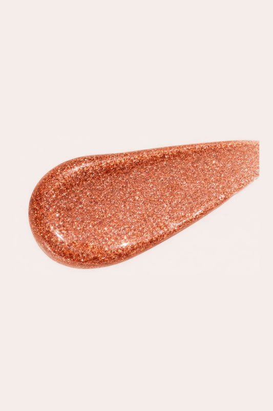 Rich copper swatch of 04 Sun Heat multi-use liquid highlighter, demonstrating a high-pigment buildable liquid shimmer formula for a bold, sun-drenched radiance.