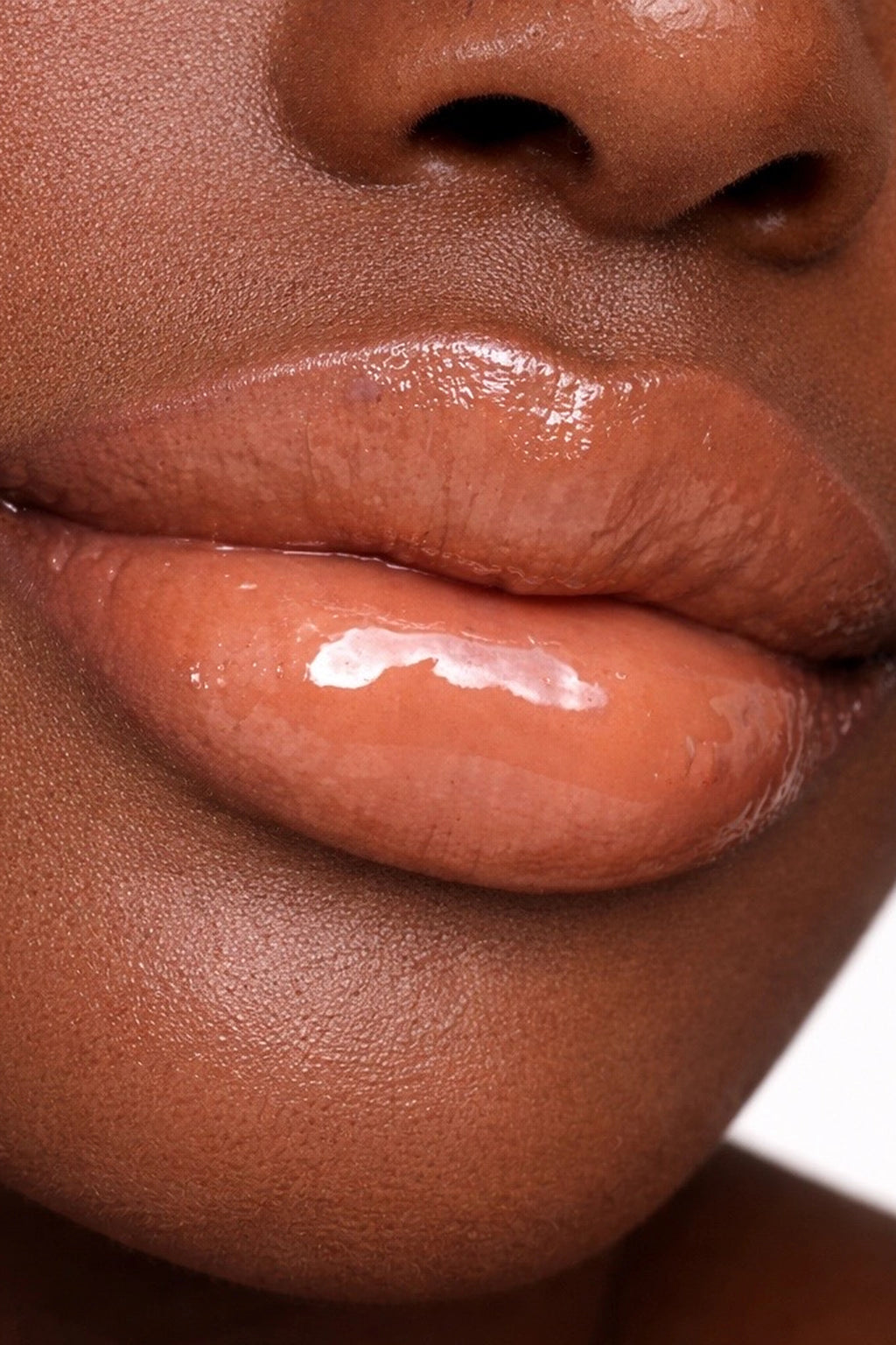 Honor The House Caribbean Sun SPF 30 Tropical Citrus on dark model with pink lips.