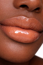 Honor The House Caribbean Sun SPF 30 Tropical Citrus on dark model with pink lips.