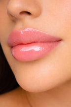 Honor The House Caribbean Sun SPF 30 Tropical Citrus on brunette model with pink lips.
